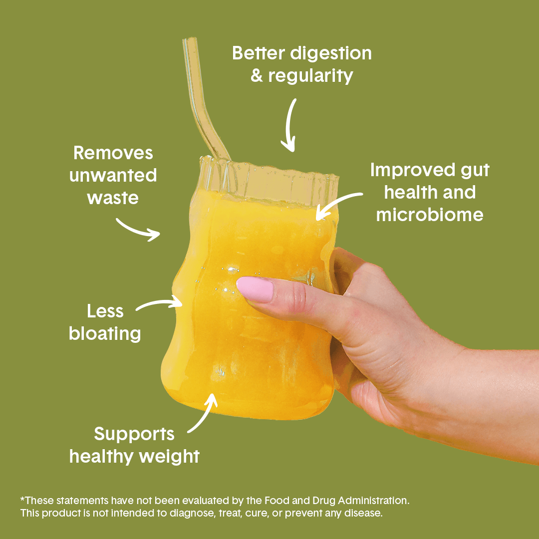 Hand holding Bellway Super Fiber supplement drink in a clear glass on a green background with surrounding text that reads: "Supports healthy weight, less bloating, removes unwanted waste, better digestion & regularity, improved gut health and microbiome."